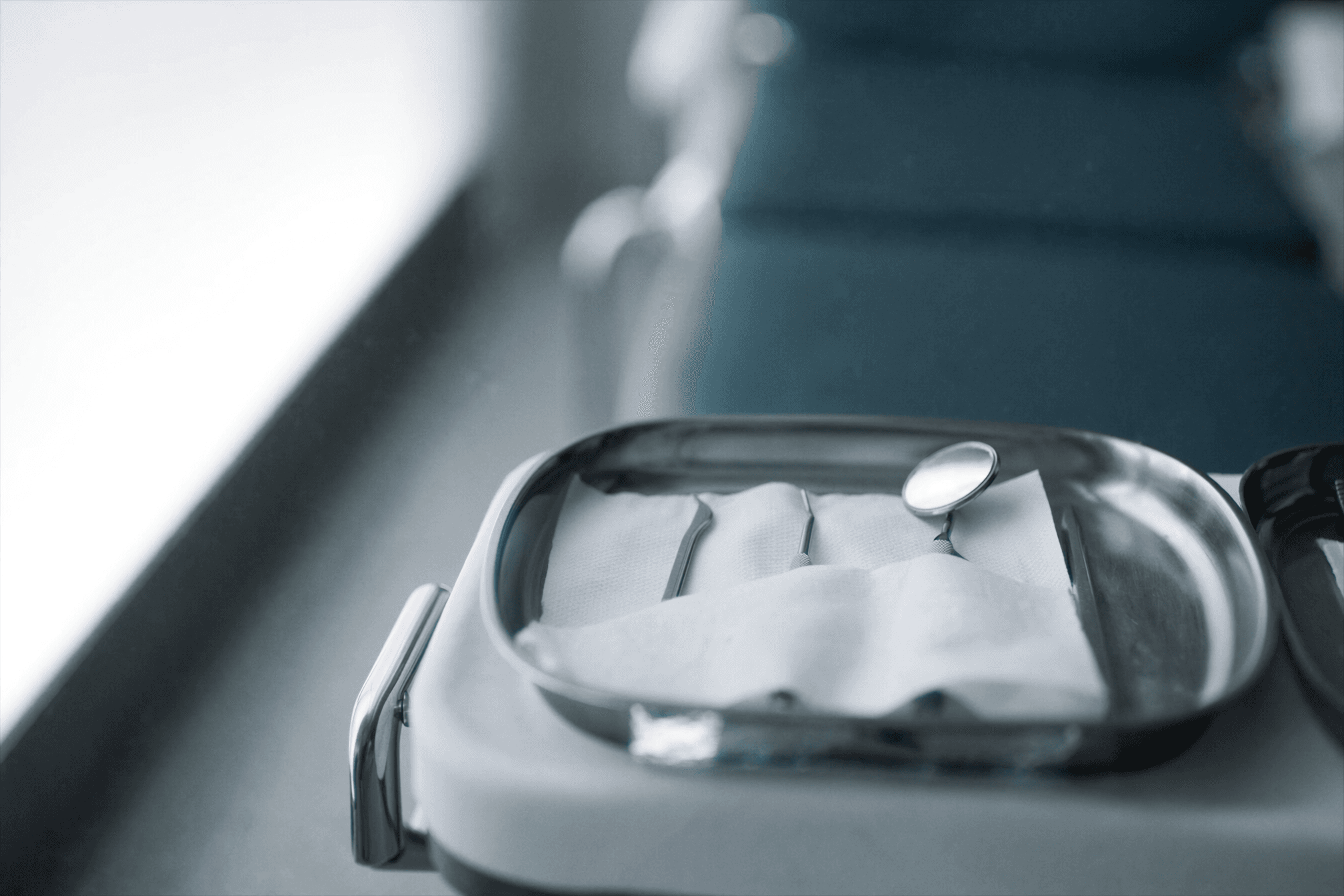 Sterile dental instruments arranged neatly on a tray under soft light